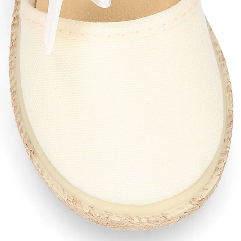Alpargata niña con LAZO SEDA en lona piqué algodón beige.