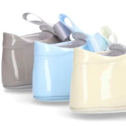 Angelito para bebés con lengüeta y lazo en piel charol.