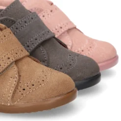 Botita niña sin cordones con lazo y picados en piel serraje.