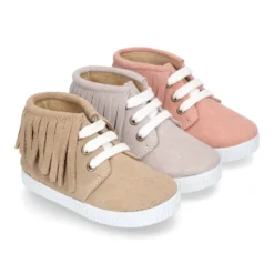 Botita tipo bamba con cordones y flecos en piel serraje.