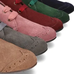 Botín tipo BLUCHER con picados y lazos en piel serraje.