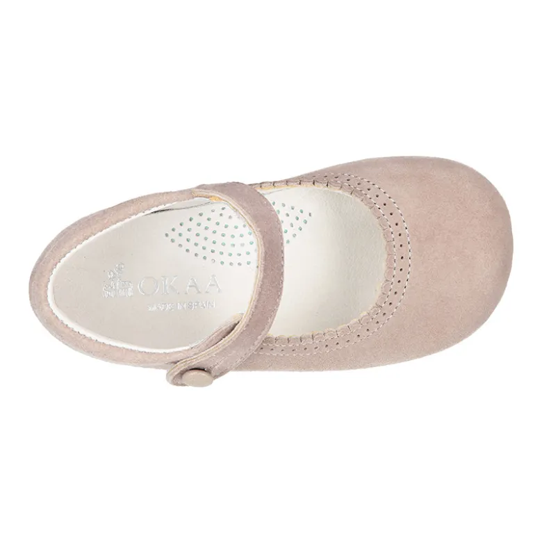 Mercedita escotada con botón en piel ante en colores pasteles.