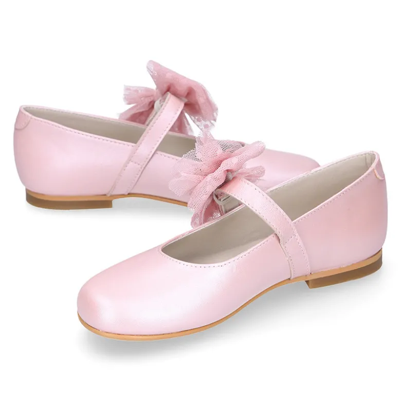 Mercedita niña ceremonia en piel rosa empolvado con flor de tul.