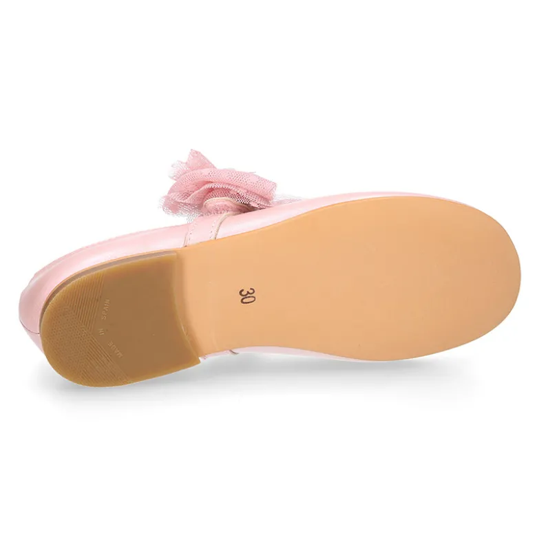 Mercedita niña ceremonia en piel rosa empolvado con flor de tul.