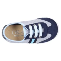 Tenis niño combinado en lona con cordones.