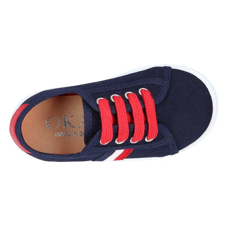 Tenis niño con cordones en lona con bandera.