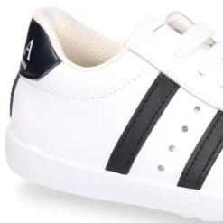 Zapatilla niños colegial OKAA con cordones, rayas laterales y puntera reforzada en piel lavable.