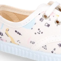 Zapatilla niños tipo Bamba con cordones en lona con DINOSAURIOS.