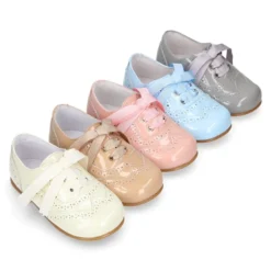 Zapatito tipo Blucher con lazo y picados en charol y colores dulces.