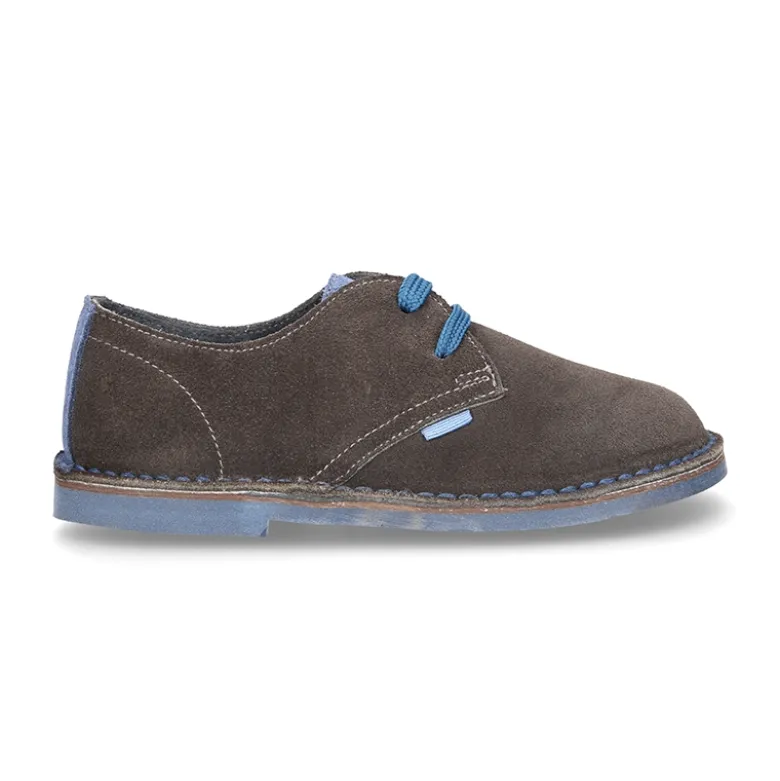 Zapatito tipo blucher con lengüeta, cordones y suela combinado en piel serraje.