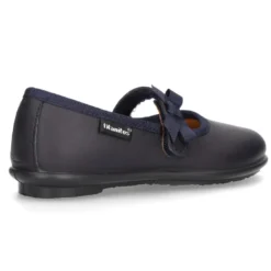 Zapato colegial tipo Mercedita con cierre adherente con lazo en piel lavable para niñas.
