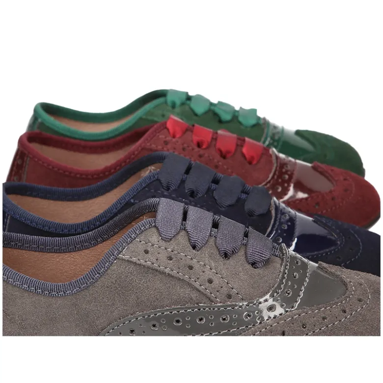 Zapato tipo Blucher niña combinado con lazos en piel serraje y charol.